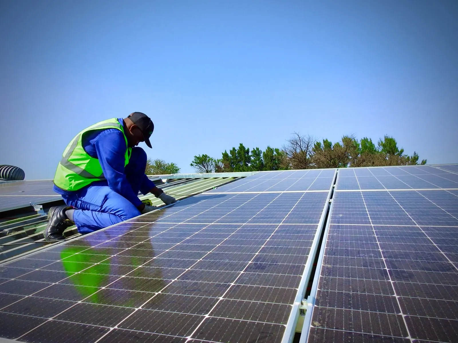 A GreenMatters engineer securing rooftop solar panels